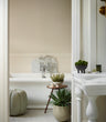 Faux Potted Dianthus in a three legged 101 Copenhagen duck bowl in a bathroom setting with a hyper realistic Agave in Green, featuring long, pointed green leaves with cream edges, displayed in a decorative planter on the floor of a light, elegant interior.