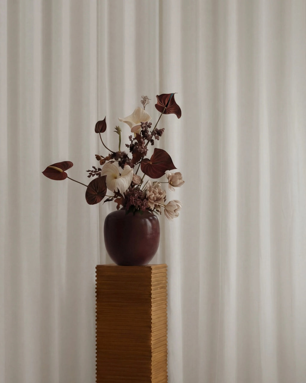 Sunao Vase Mini in Maroon by 101 Copenhagen, featuring a rounded silhouette, narrow opening and deep reddish-brown glossy ceramic finish, photographed against a white background.