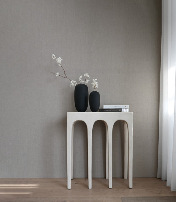 A pair of 101 Copenhagen Sunao Slim vases in black, styled with faux blossom sprays.