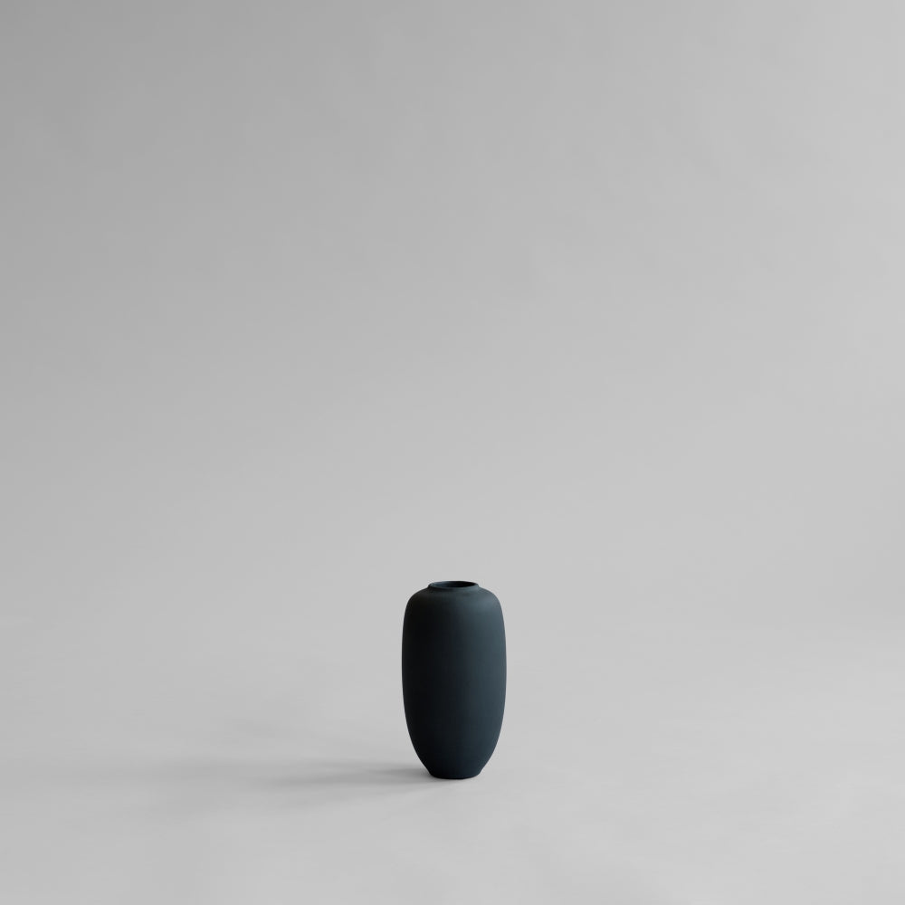 101 Copenhagen Sunao Slim black vase on a light gray background ready to be styled with faux flowers and plants 
